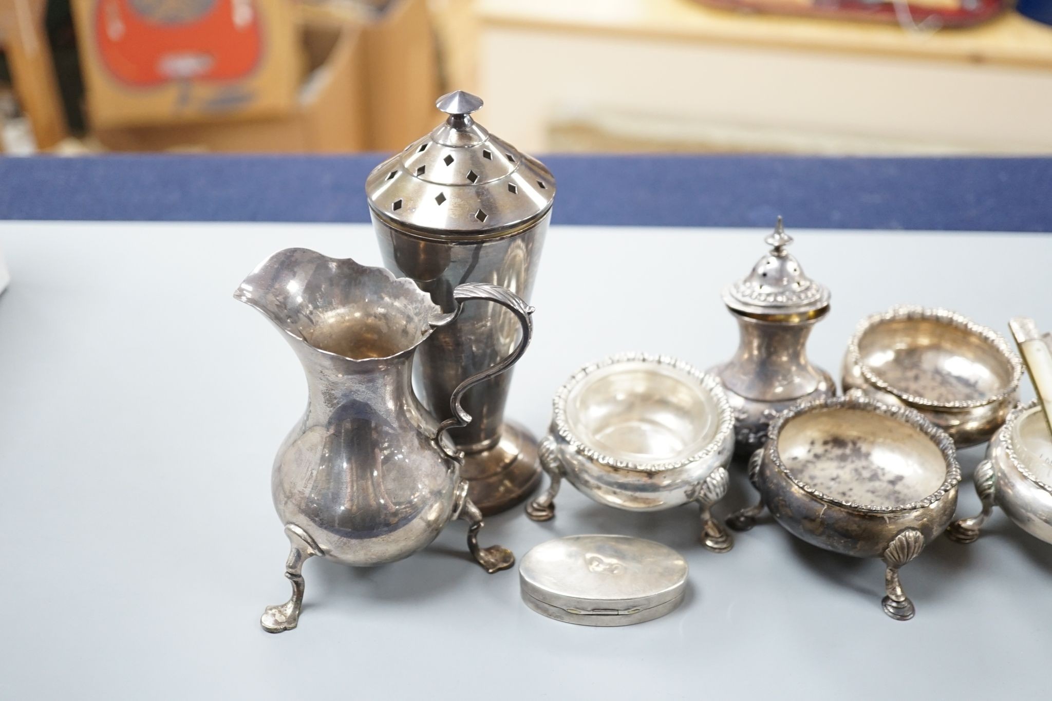 Sundry silver including four Georgian salts, and Art Deco sugar caster, cream jug, condiment and fruit knife.